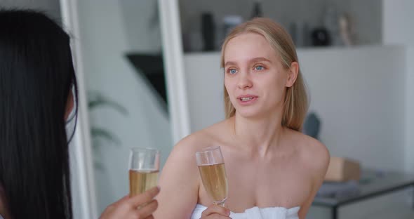 Closeup of Two Delighted Beautiful Multiethnic Women Chilling Together at Henparty in Home Bathroom alt