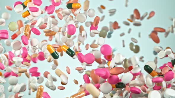 Super Slow Motion Shot of Flying Colorful Pills on Gradient Background at 1000Fps alt