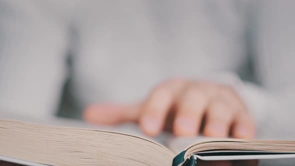 Reading a Book and Turning the Pages Close Up Slow Motion alt
