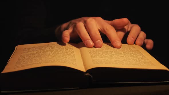 Reading an Old Book Under Vintage Yellow Lamp Lighting alt