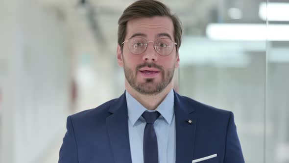 Disapproving Young Businessman Saying No By Head Shake alt