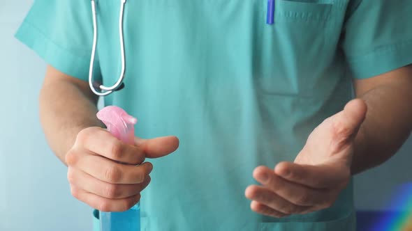 Doctor Spray Disinfectant on His Hands. Medic Squirting on Arm Disinfectant Solution. Using an alt