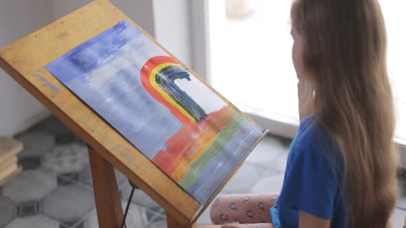 A Talented Preschooler Draws a Picture with Paints