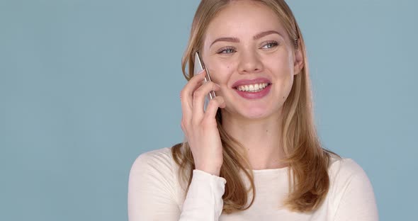 Cute Happy Young Woman Talking with Someone on Her Smartphone alt