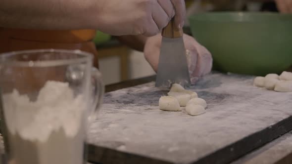 Chef cuts gnocchi with spatula slowmotion