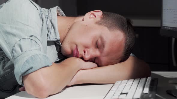Man Sleeping on the Table in Front of the Computer alt