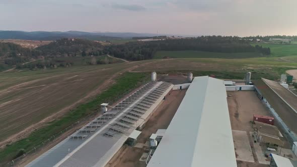 Aerial footage over chicken farm covered with solar panels in northern Israel alt
