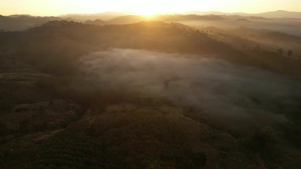 4K Aerial view from drone over mountains fog. Golden scenery at sunrise, Nan, Thailand alt