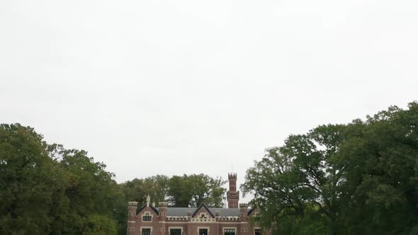 Tilt down from cloudy sky to Schaffelaar Castle in Barneveld, the Netherlands alt