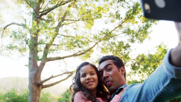 Father and daughter taking a selfie alt