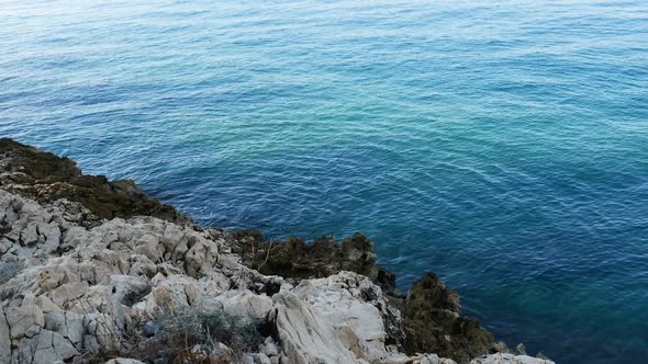 Rocky Coastline And Calm Blue Sea