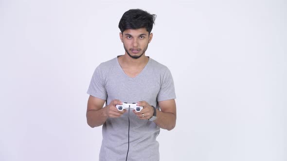 Young Tired Bearded Indian Man Playing Games and Falling Asleep alt