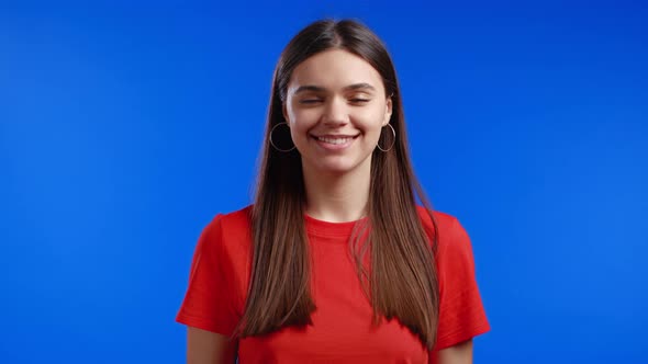 Cheerful Woman Showing Yes Sign Nods Her Head Approvingly