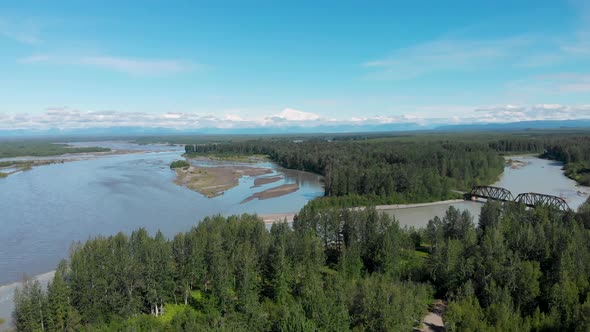 4K Drone Video of Alaska Railroad Train Trestle Bridge with Mt. Denali in Distance near Talkeetna, A alt