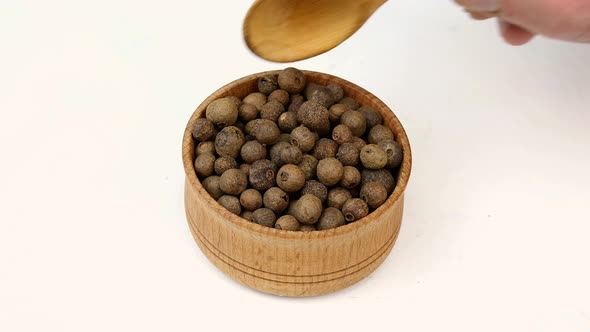 Chef Taking Dry Allspice Peas From Wooden Spice Jar for Preparation Savory Tasty Food alt