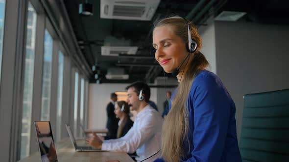 Young Lady Employee Happy of Conversation with Customer Calling By Headset alt