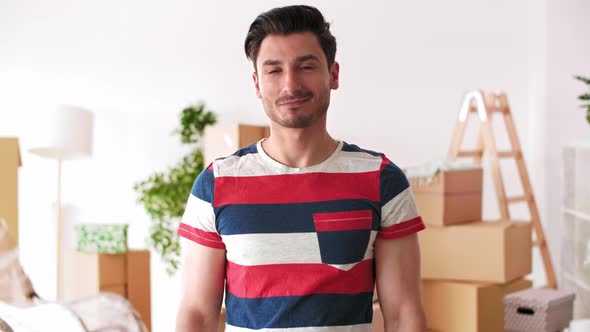 Young man holding key ring to his new house   alt