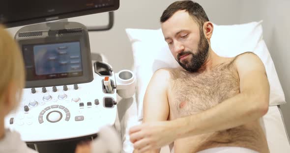 Doctor Examining Liver of Male Patient with Ultrasound Scan in Clinic alt