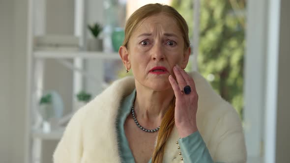 Mirror POV of Desperate Middle Aged Woman Looking at Wrinkles with Hopeless Facial Expression alt