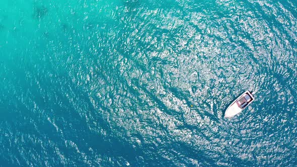 Aerial Top View of a Fishing Boat Sailing in Turquoise Waters of Ocean Zanzibar alt