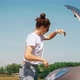 A Woman Opens the Hood of a Car and Looks at the Engine - VideoHive Item for Sale