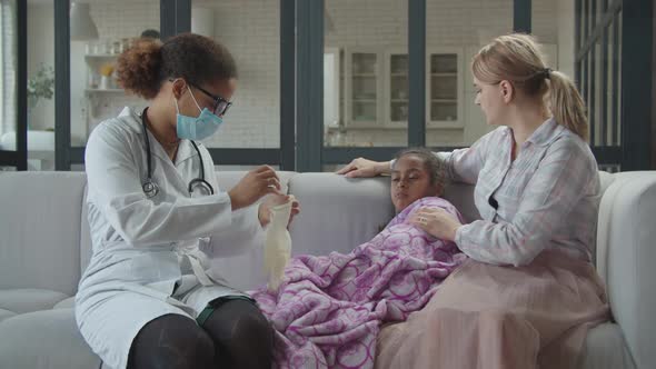 Female Pediatrician Doing Medical Checkup at Home alt