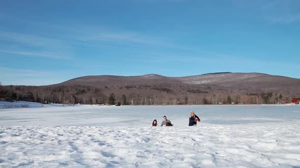 Family walking in the snow alt