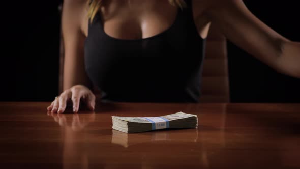 Sexy woman with a stack of money alt