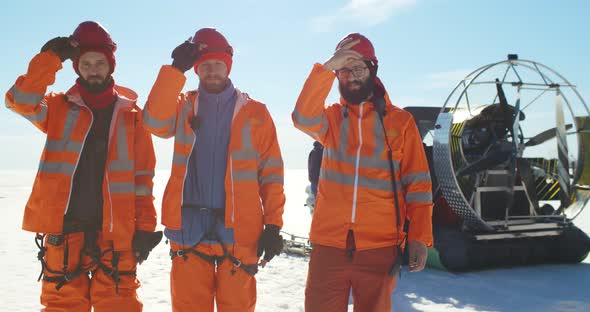 Professional Lifesavers Putting on Hardhat Working in Arctic alt