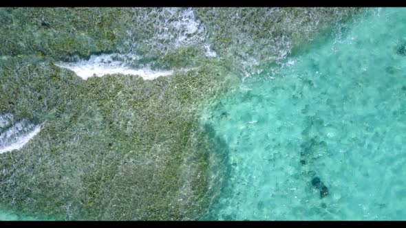 Aerial top down abstract of luxury tourist beach adventure by aqua blue ocean with white sandy backg alt