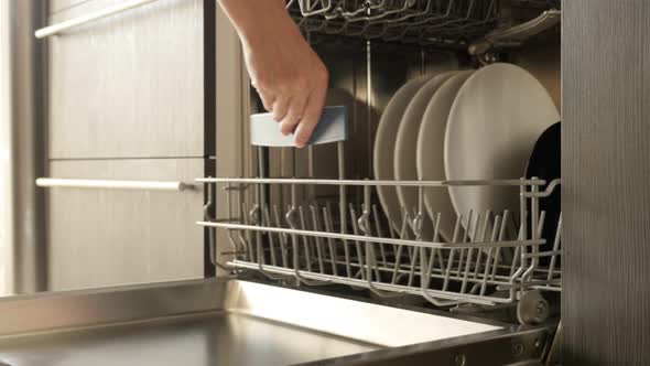 Closing dish washing machine door 4K 2160p 30fps UltraHD footage - Dishware inside  built-in dishwas alt