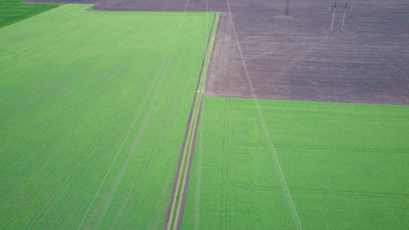 High voltage post Power line High voltage tower in the field. power lines on green fields alt