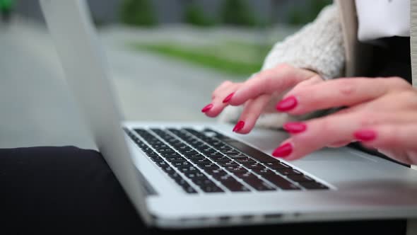 Female Fingers Pressing a Keys on Contemporary Laptop alt