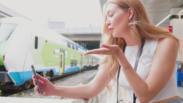 Slow motion young caucasian woman outdoor using smartphone videocalling