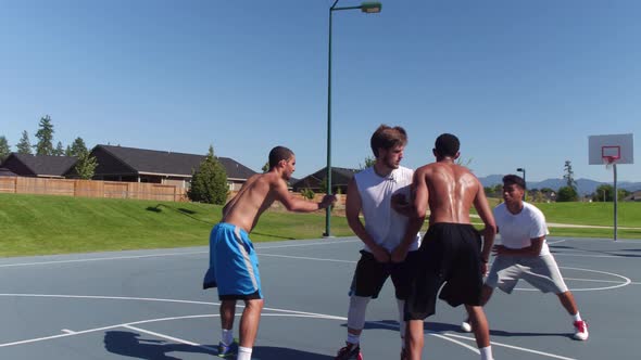 Friends playing basketball at park