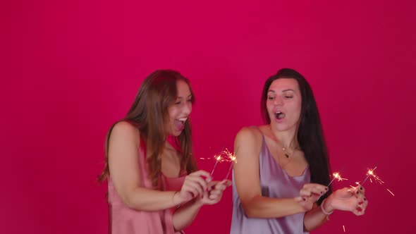 Lesbian Couple of Two Pretty Young Girls Dance with Burning Sparklers Having Fun