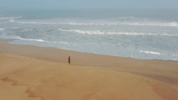 Man Strolling Along the Shoreline Within Perfect Summer Destination alt