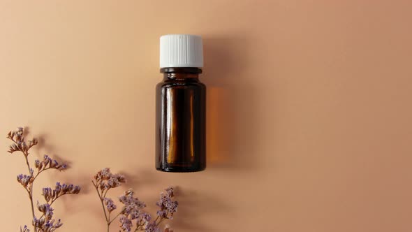 Herbal essential oil glass bottle mockup beige flowers background Spa aromatherapy beauty cosmetics