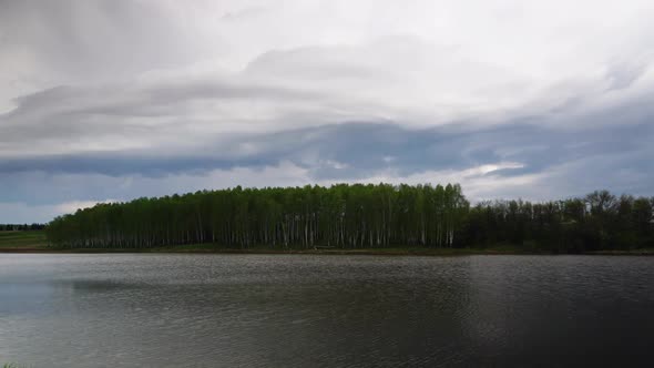 Dark Storm Clouds Fast Moving Over Lake Timelapse alt
