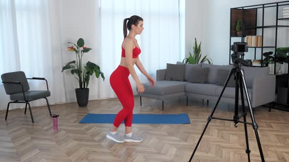 Fit Woman Fitness Trainer Blogger Doing Exercise Workout Training at Modern Home alt