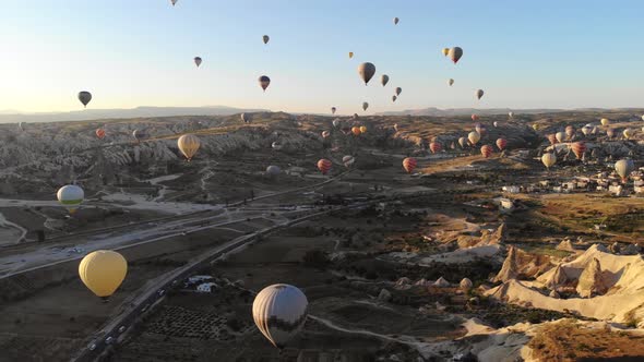 Aerial Hot Air Balloons Flying Over Hoodoos and Fairy Chimneys in Goreme Valley Cappadocia, Turkey alt