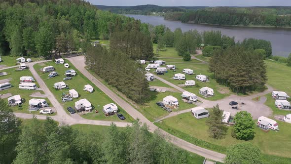 Awesome Aerial Shot of a Caravan Park Next to a Lake alt