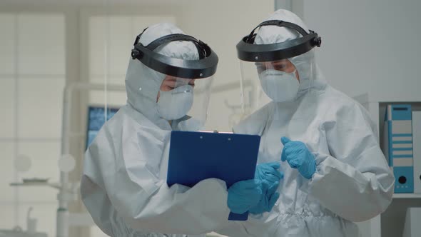 Close Up of Dentistry Doctors Talking Wearing Hazmat Suit alt