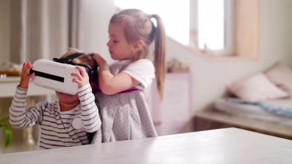 Girl Putting VR Goggles on Little Brother