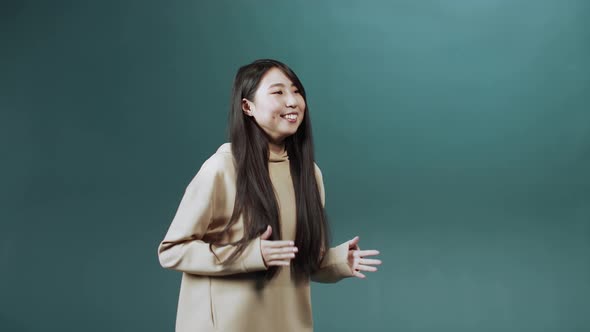 A Young Asian Lady is Dancing Delightfully in Slow Motion alt