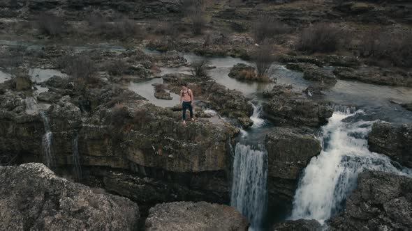 Aerial view of Man  walking through the stone of Niagara Waterfall on the river Cijevna alt