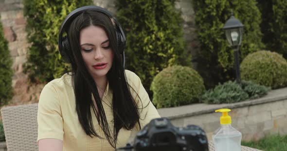 Live Stream in Garden of Blogger Recording Speech to the Camera alt