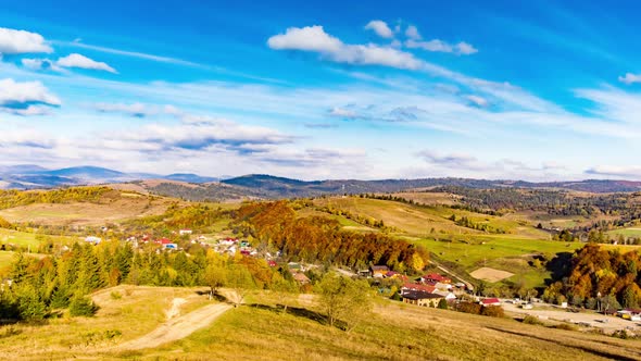 Small Village in Highland Under Blue Sky with Heavy Clouds