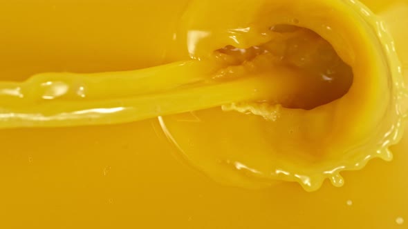 Super Slow Motion Shot of Pouring Orange Juice at 1000Fps alt
