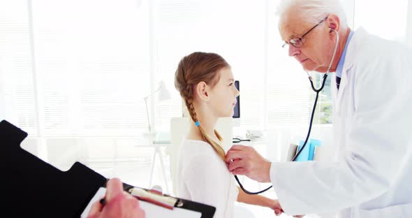 Male doctor examining a patient alt